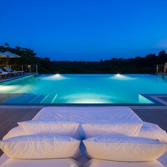 Serene infinity pool glows with inviting turquoise water under a twilight sky, framed by lush trees