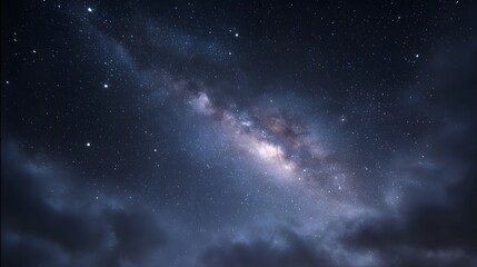 Fototapeta premium A stunning view of the Milky Way galaxy stretching across a dark star filled night sky with ethereal clouds