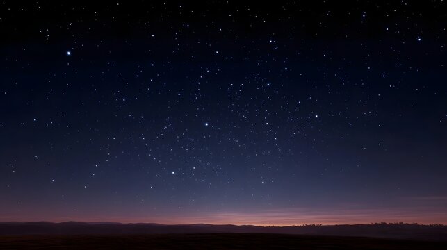 A vast clear night sky filled with countless twinkling stars above a dark tranquil horizon at twilight