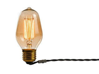 A single light bulb with a golden filament emitting a warm glow png transparent