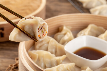 Chinese Breakfast Dumpling Lifted With Chopsticks