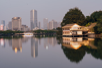 Obraz premium City Skyline and Traditional Pavilion Reflecting in Calm Lake - Huizhou West Lake