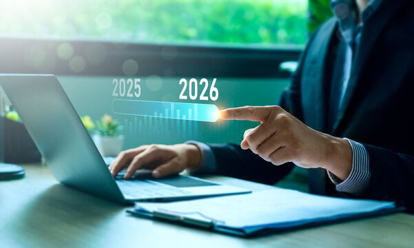 Business professional interacting with digital timeline from 2025 to 2026 on laptop, illustrating strategic planning, financial forecasting, data analysis, and future focused corporate decision making