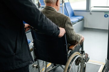 Elderly Man in Wheelchair Assisted onto Public Bus by Kind Helper with wheelchair, accessibility, man, senior, bus, disabled, elderly