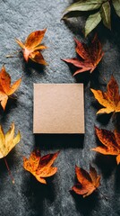 Flat Lay of Colorful Autumn Leaves Framing a Beige Square on a Dark Textured Glittering Surface in a High Angle Composition with a Focus on Seasonal Textures