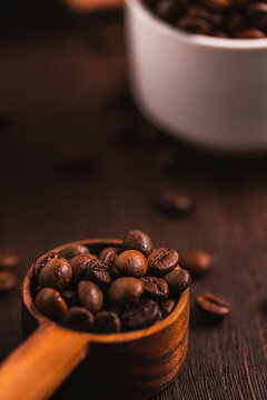Dark Coffee Beans Background with Rustic Scoop