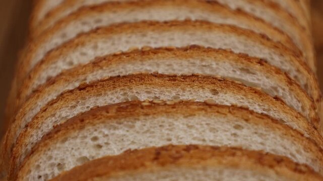 Slices of bread stacked neatly showing layers in a well-lit kitchen setting