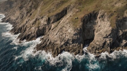 Coastal cliffs meet churning waves, rugged landscape