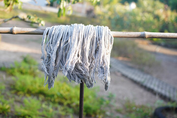 The mop is hung on a bamboo rack.