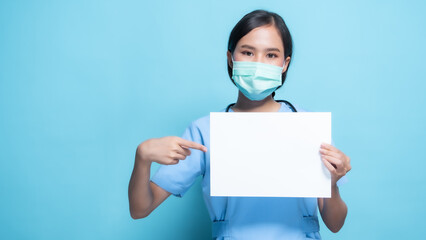 Female Nurse Wearing Mask Holding Blank Sign on Blue Background