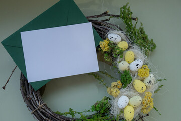 White envelope mockup copy space greeting card. Candid Easter wreath arrangement decor. Handmade craft creative present or gift idea. Zero waste eco-friendly springtime holiday decoration. 