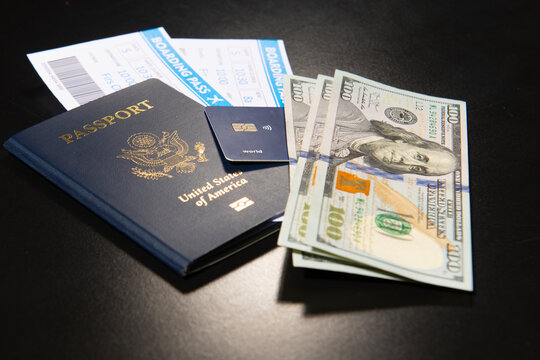 US passport with boarding pass. American passport with cash and credit. Travel and money for trip. American passport and airline tickets with US dollars for travel. Passport boarding pass for travel.