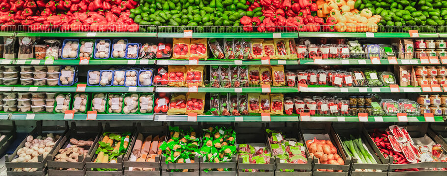 Supermarket showcase of vegetables and fruits. The department of fresh vegetables and fruits in the store, grocery merchandising. High quality photo