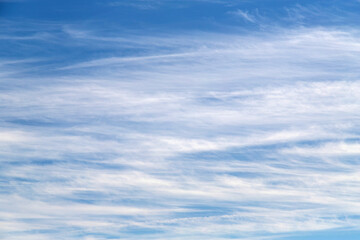 Clear Blue Sky With Soft White Clouds Over a Calm Day