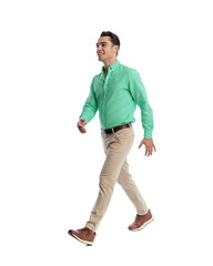 Happy young man walking and looking away