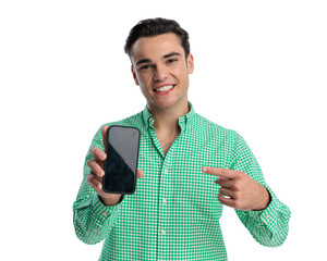 Enthusiastic young man pointing at smartphone screen