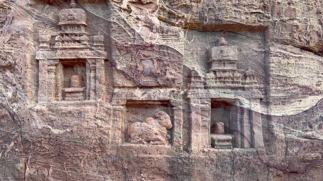 A beautiful Shiva Linga with Nandi carved from red sandstone rock, showcasing intricate Chalukyan craftsmanship and devotion in the rock-cut temple architecture of Badami.