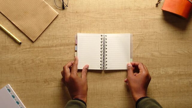 Opening a notebook and preparing to write notes