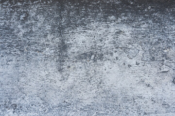 Fototapeta premium Grungy weathered concrete texture with varying shades of grey and dark surface marks