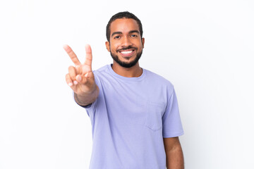 Fototapeta premium Young Ecuadorian man isolated on white background smiling and showing victory sign