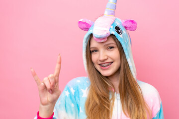 Teenager Russian girl with unicorn pajamas isolated on blue background © luismolinero