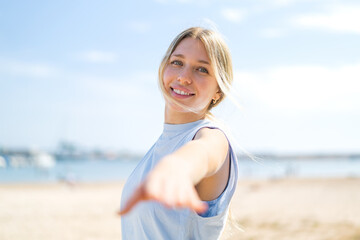 Young blonde woman at outdoors doing yoga
