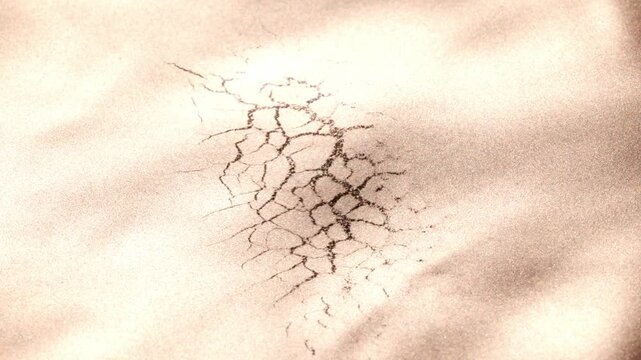 Dynamic slow-motion video of dark golden paint dissolving and merging, revealing complex, spreading webbed structures that dissolve back into fluid surface.