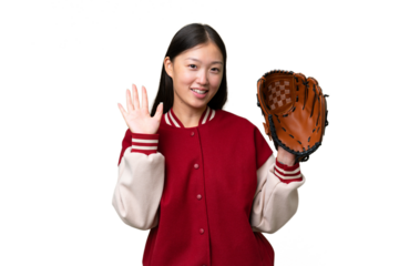 Young asian woman with baseball glove over isolated background saluting with hand with happy expression