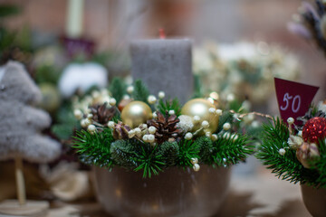 Beautiful holiday centerpiece featuring a candle, ornaments, and seasonal greenery in a festive setting