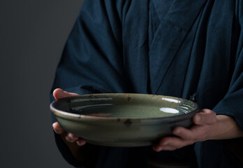 皿を持つ陶芸家の男性 © polkadot