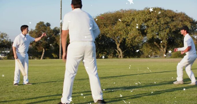 Batsman, bowler releasing ball, fielder diving securing it in park, stars appearing around players