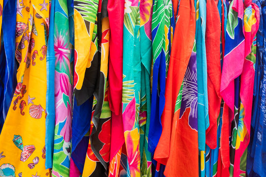 line of colorful fabric texture background with sarongs or pareos on outside market in asia or africa