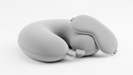 A gray, contoured neck pillow with a headrest, designed for travel comfort.