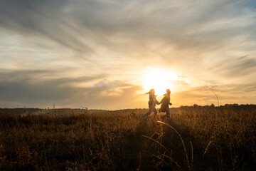 Young couple Silhouetted Figures in a Golden Hour Landscape