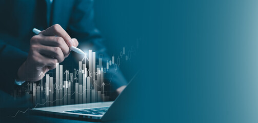 Business analyst using digital pen to analyze financial growth chart on laptop, representing data analytics, investment strategy, stock market performance, business finance, and modern technology.