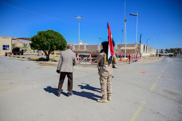 Yemeni Soldier Carrying National Flag Next to Civilian in Public Area
