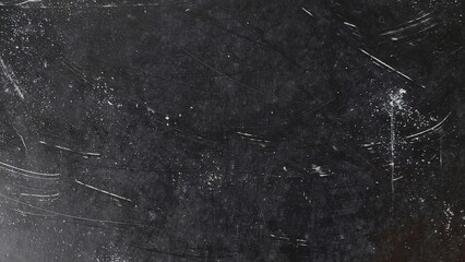 Dark grunge black background filled with dust noise and scratches. Dirty abstract texture with worn black surface overlay. White dust particles and scratch details on black background.