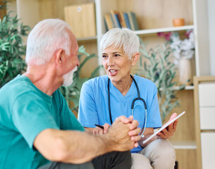 Doctor or nurse caregiver showing a tablet screen to  senior man at home or nursing home