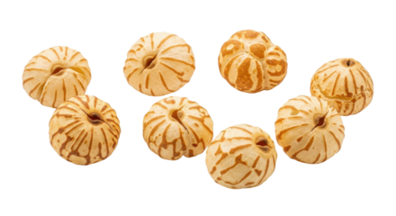 Seven small round baked goods with brown stripes on black background food pastry