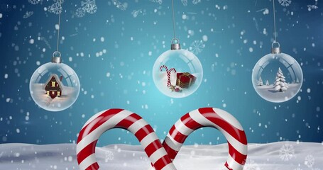 Animation of candy canes, snow falling over christmas baubles in winter scenery - Powered by Adobe