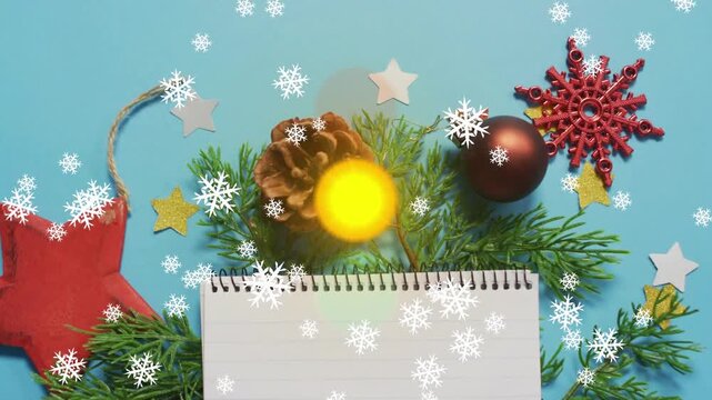 Snowflake drifting over flat lay then orbs appearing shifting stacking and pulsing above pine cone