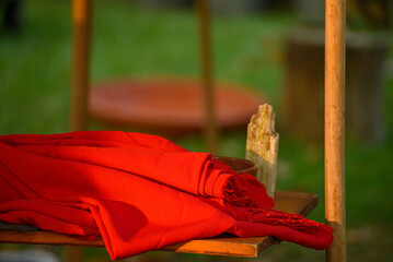 Red cloth on a wooden shelf at sunset the concept of simplicity