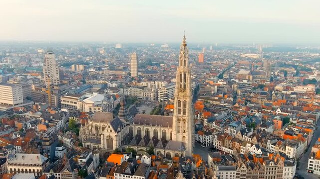 Antwerp, Belgium. Spire with the clock of the Cathedral of Our Lady (Antwerp). Historical center of Antwerp. City is located on river Scheldt (Escaut). Summer morning. Drone footage