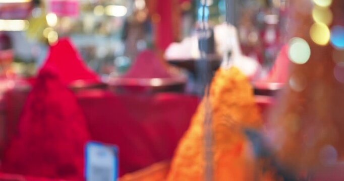 Vibrant gulal, rangoli colors, and traditional pooja items like turmeric and kumkum are displayed in a lively Indian pooja market, showcasing rich festive culture
