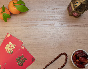 Festive cultural arrangement with red envelopes, dates, and oranges