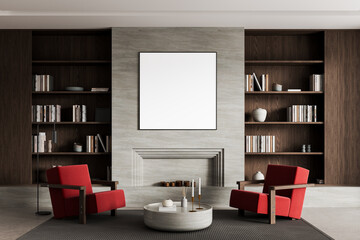 Modern living room interior with blank framed poster on fireplace wall, red armchairs, wooden bookshelves and coffee table in elegant layout concept. 3D Rendering