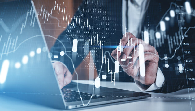 Businessman analyzing digital stock market chart with futuristic interface on office background showing investment and financial growth concept.. - Powered by Adobe