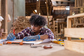 Two carpenters reviewing woodwork design plans © Washburn