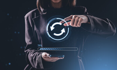 Businesswoman interacting with virtual update icon above smartph