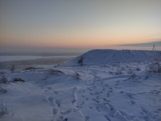 Snow-covered winter valley in the evening